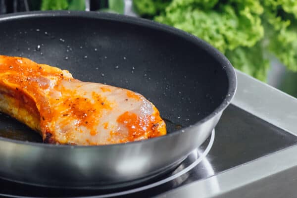 Magefesa_ caramelized pork in a stainless steel skillet_Delicia
