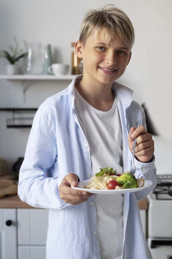 red young boy eating healthy food -